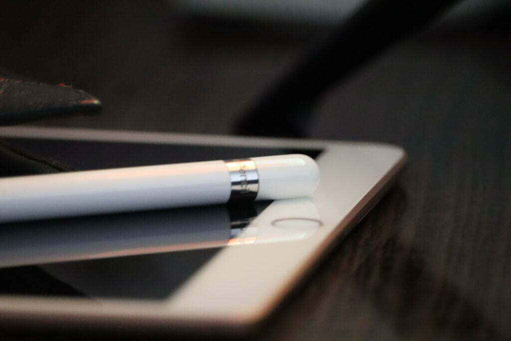 close up image of the bottom half of an ipad and ipad pen against a dark brown background for the article Hard opt-in vs soft opt-in What is the difference