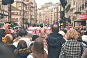 image of crowd holding up cell phones for article Getting Your Email Frequency Just Right