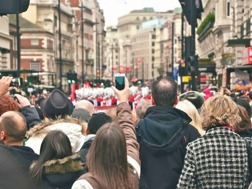 image of crowd holding up cell phones for article Getting Your Email Frequency Just Right