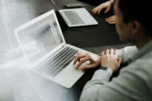 image of individual using a laptop for email capacity popcorn article