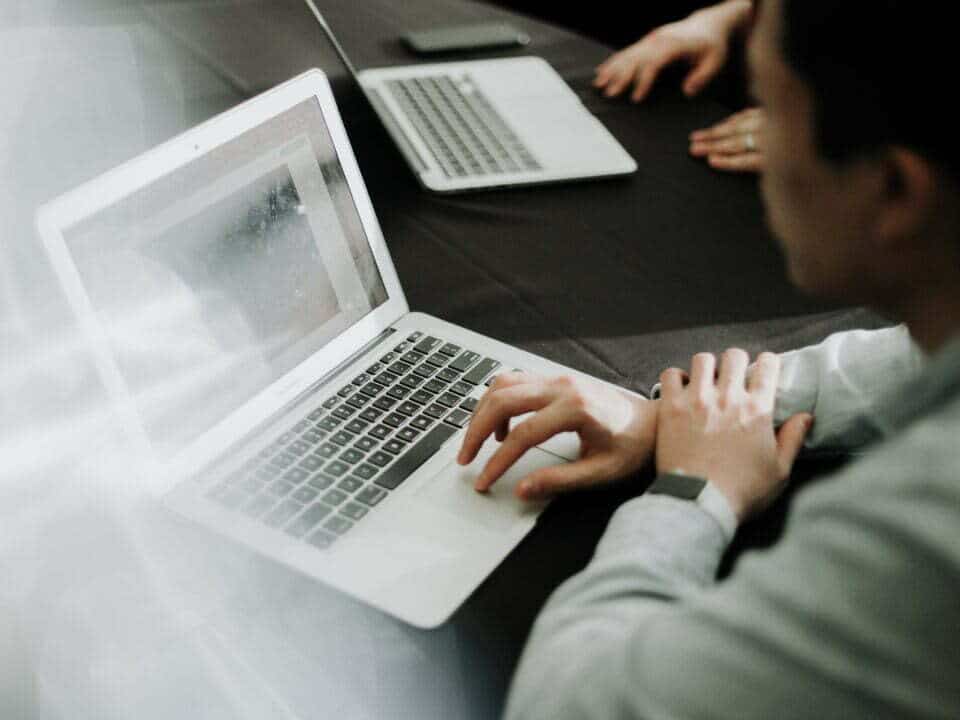 image of individual using a laptop for email capacity popcorn article