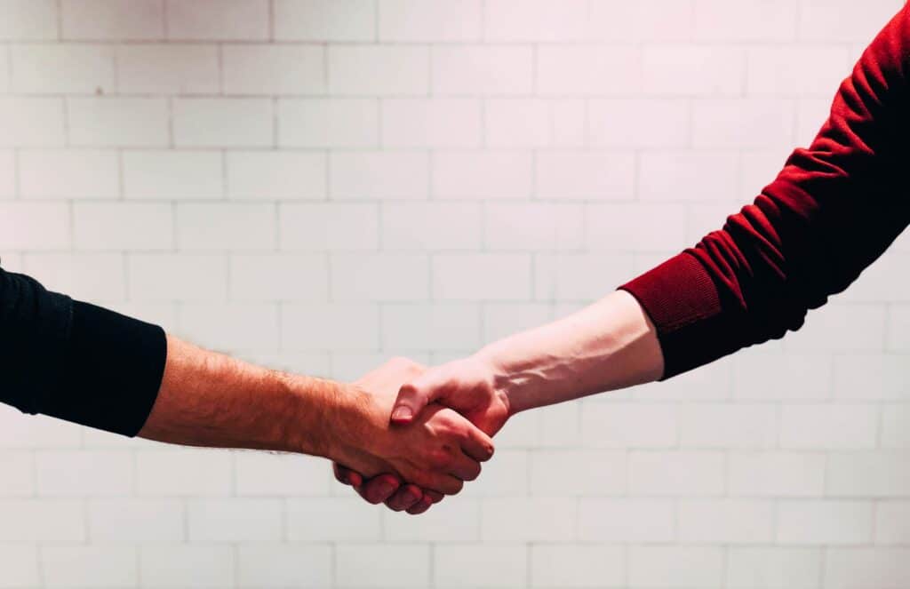 two men shaking hands for 4 types of video content marketing game