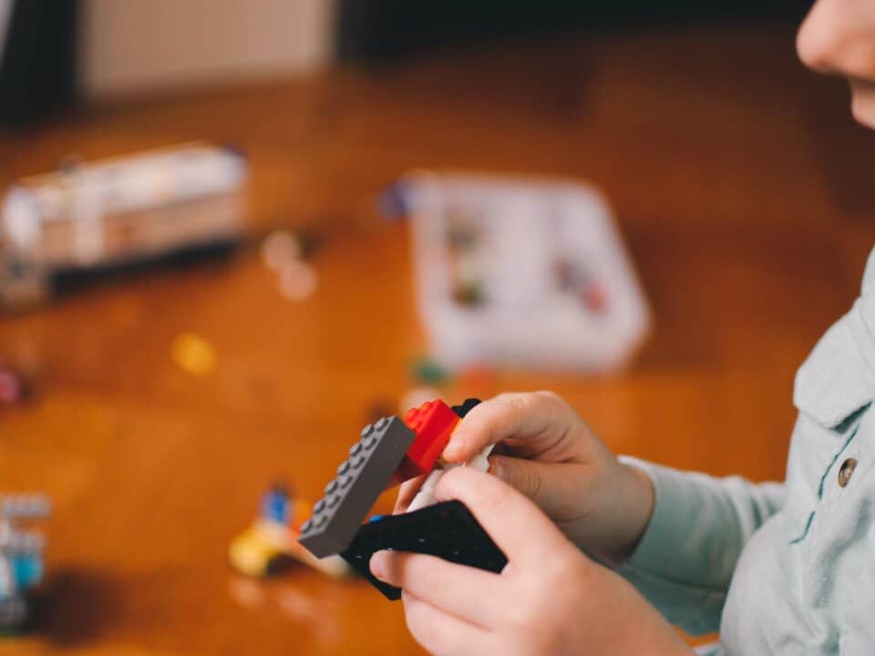 small child playing with lego to indicate building sales pipelines popcorn