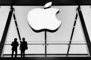 silhouette of people standing below white apple logo ios 15