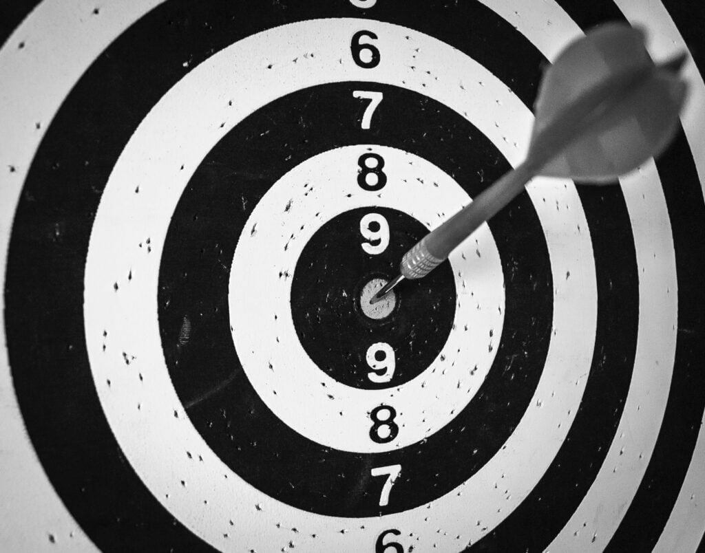 black and white target with arrow in middle