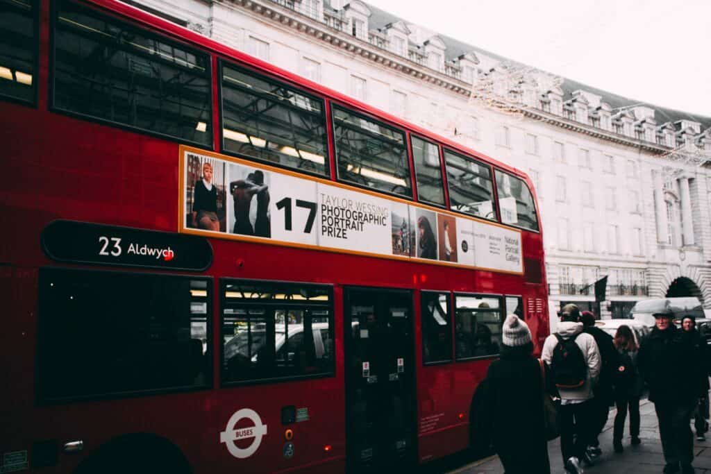 red double bus in london at christmas with advert on side of bus how to optimise your multi channel marketing for small business article