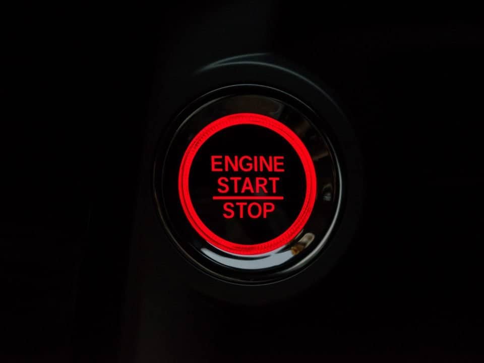 red and black car button with the words 'engine start/stop' in red for popcorn crm for small business article