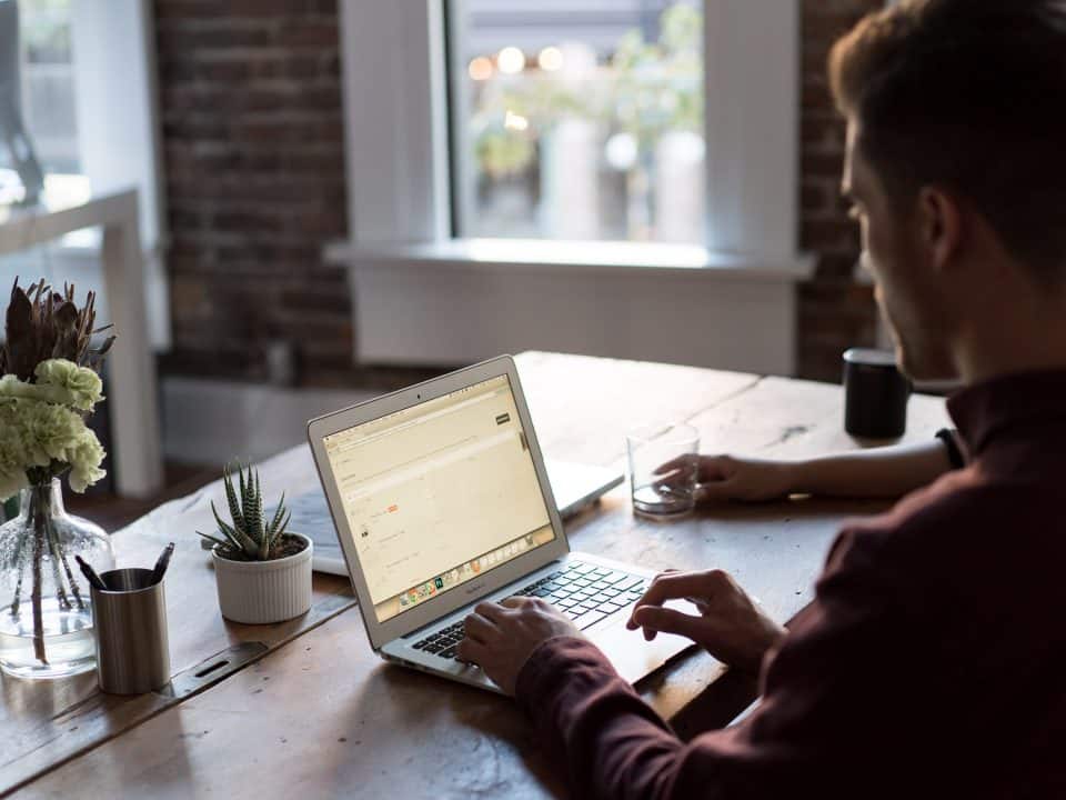 man on laptop in an office for crm comparisons article