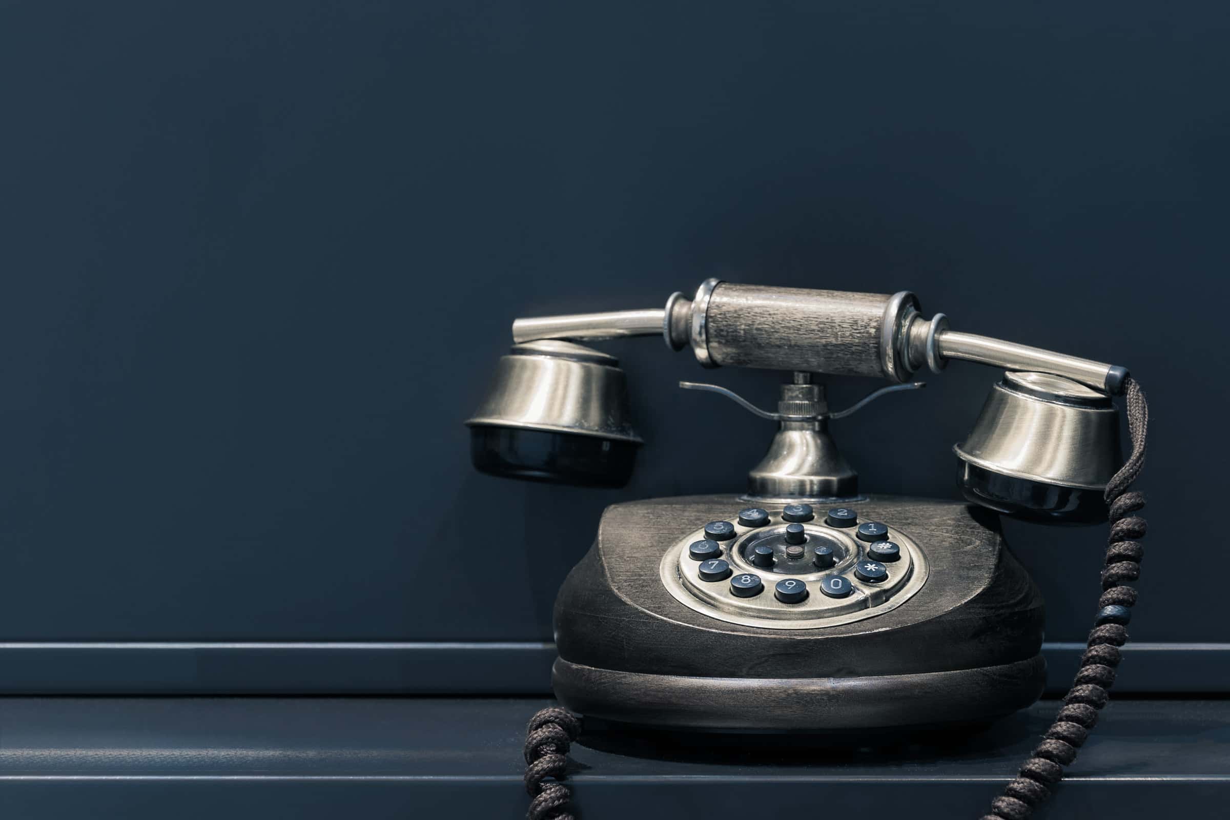 old telephone against black background for ai automation article