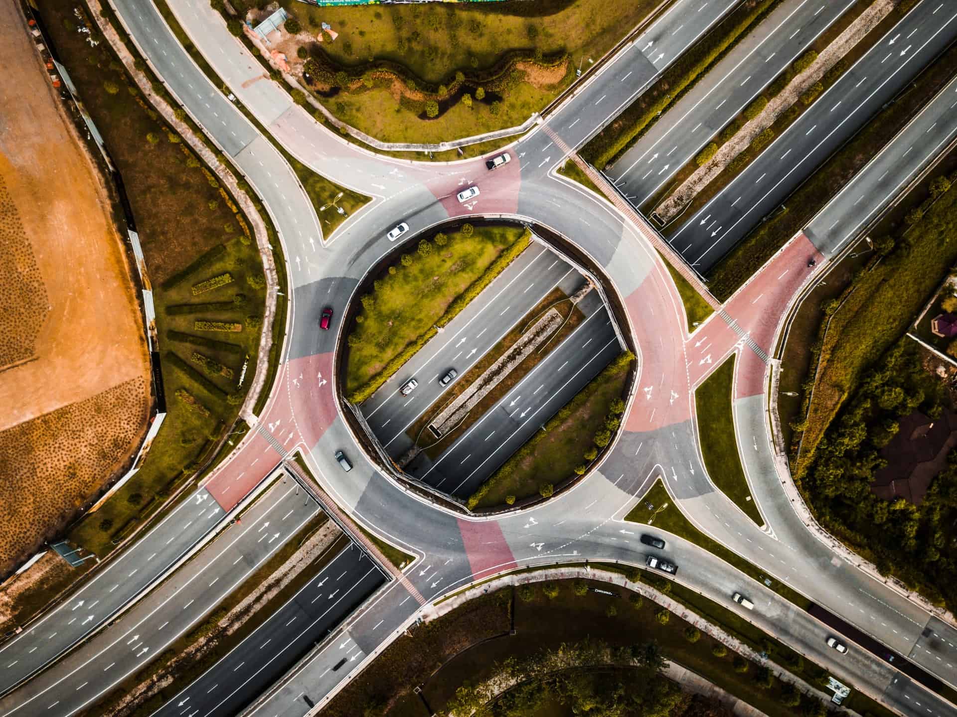 aerial photo of vehicles driving on a roundabout for buying cycle article